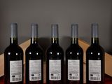 four bottles of wine are lined up on a table