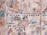 three pieces of ancient art are displayed on a white surface