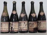 six bottles of wine are lined up on a table