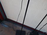 a floor lamp that is on the ground next to a wall