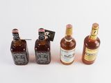 several bottles of liquor are lined up in a row on a white surface
