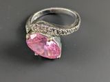 an image of a pink diamond ring on a black surface