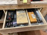 a drawer full of assorted tools on a workbench