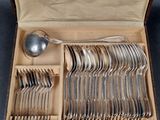 a box full of silverware with a spoon and spoon in it