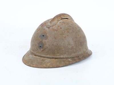 an old helmet that is sitting on the ground