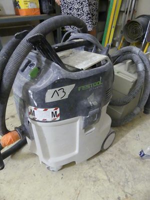 a vacuum that is sitting on the floor in the garage