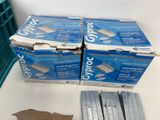 several boxes of clorox are sitting on a table next to a green crate