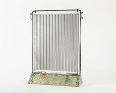 a metal radiator that is sitting on a stand