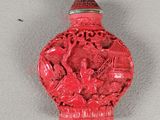 a red glass bottle with a picture of a man and a woman on it