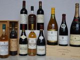 many bottles of wine sitting on a table next to a wooden box