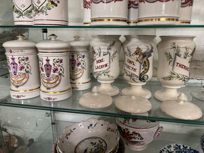 many vases and jars on display in a glass case