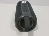 an image of a black speaker sitting on top of a white table
