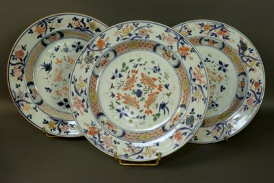 three plates with floral designs on them are sitting on a table