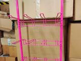 a pink rack that has a bunch of boxes in it