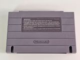 an old nintendo game console sitting on top of a white table