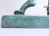 statue of a man on a skateboard on a base with a skateboard
