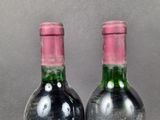two bottles of wine sitting next to each other on top of a table