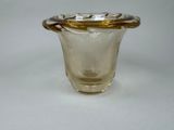 a glass vase with a gold rim sitting on a white surface