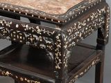 a small table with a marble top on a stand