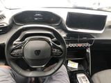 someone is sitting in the driver ' s seat of a car with their feet on the steering wheel