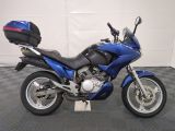a picture of a blue motorcycle parked in a garage