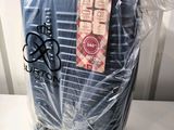 a piece of luggage wrapped in plastic on a chair