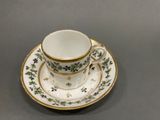 a cup and saucer on a saucer on a table