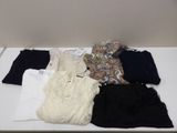 a lot of clothes that are on a white table
