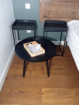 a small table with a book on it in the corner of a room