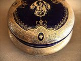 an image of a gold and blue box with a clock on it