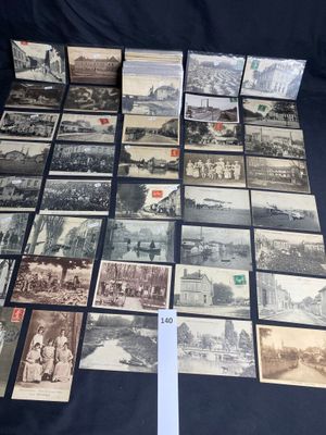 several old postcards are arranged on a table with a white ribbon