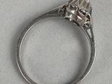 a close up of a ring with a diamond on it