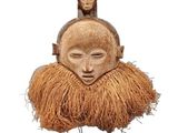 an image of a wooden mask with a man ' s face on top of it