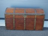 a large wooden chest sitting outside on the street