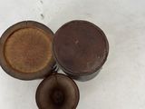 a small wooden box with a lid on a white surface