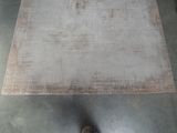a person standing next to a rug on the floor