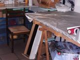 a room with a table, chairs, and other items in it