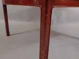 an old wooden table with a glass top on a white background