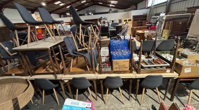 many chairs and tables in a room with a lot of boxes