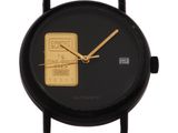 a close up of a black watch with a gold bar on the face
