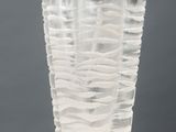 a glass vase that is sitting on a white pedestal