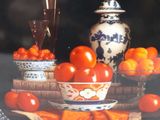 a plate with a picture of a bowl of tomatoes and a glass of wine