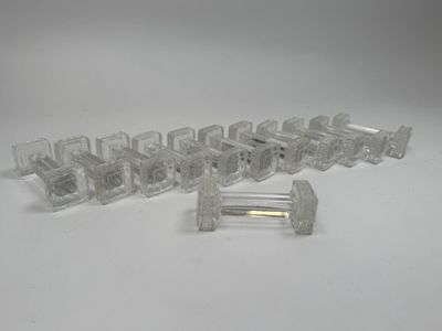 several pieces of clear plastic that are on a white surface