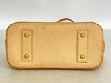 an image of a tan suitcase sitting on top of a table
