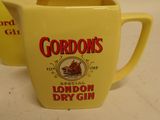 two yellow mugs sitting on top of a counter with gordon ' s logo on them