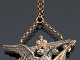 an image of a gold and silver necklace with an eagle on it