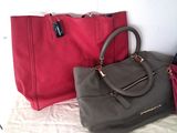 two bags sitting next to each other on a bed