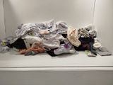 une pile de vêtements posée sur une étagère blanche