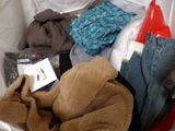 a pile of clothes in a plastic container with a tag on it