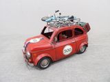 a red toy car with a bike on top of it